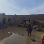 Afghanistan flood destruction with collapsed homes and muddy water after heavy rainfall disaster